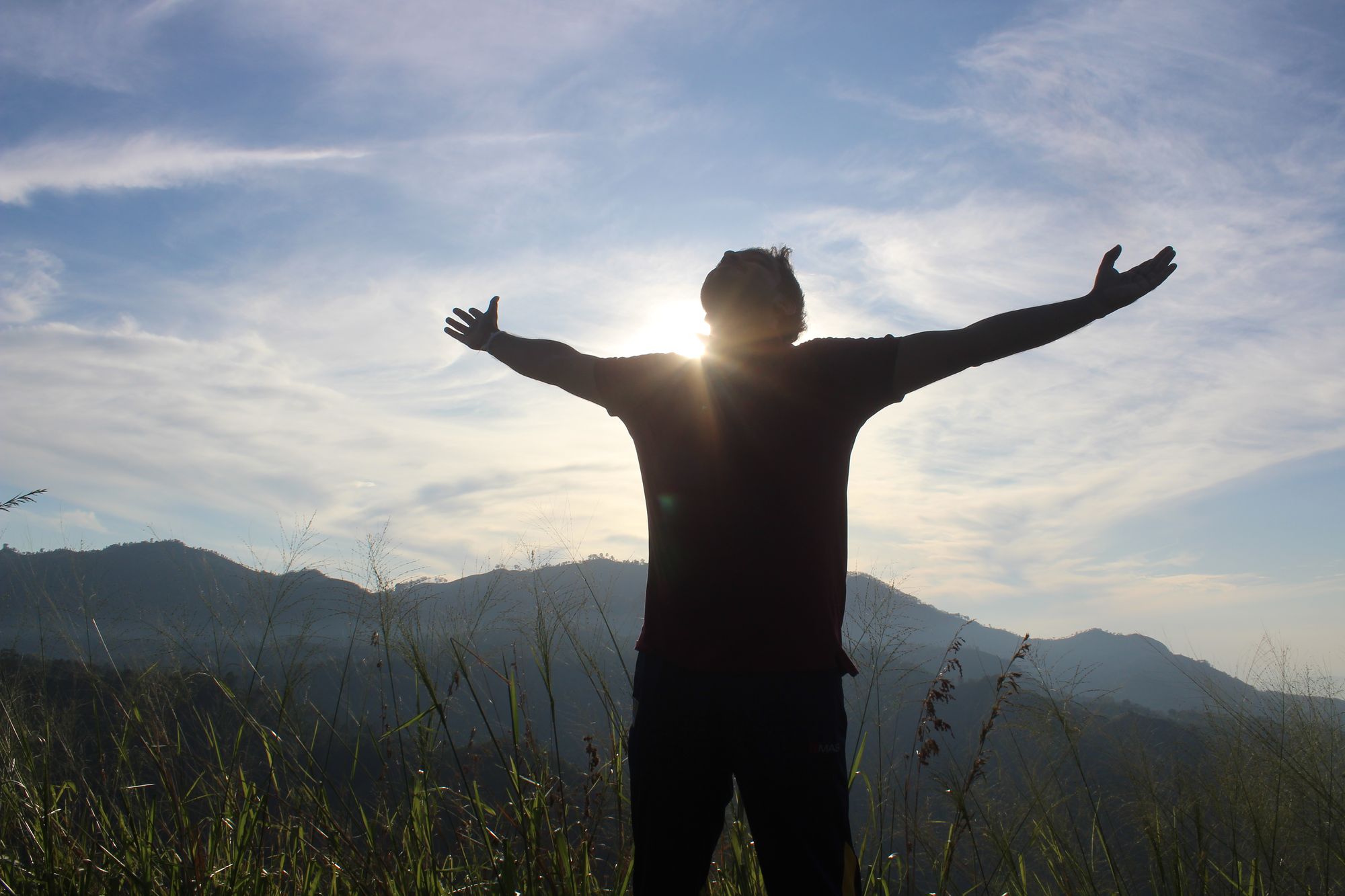 A man enjoying the sunrise from Little Adam's Peak in Ella, Sri Lanka