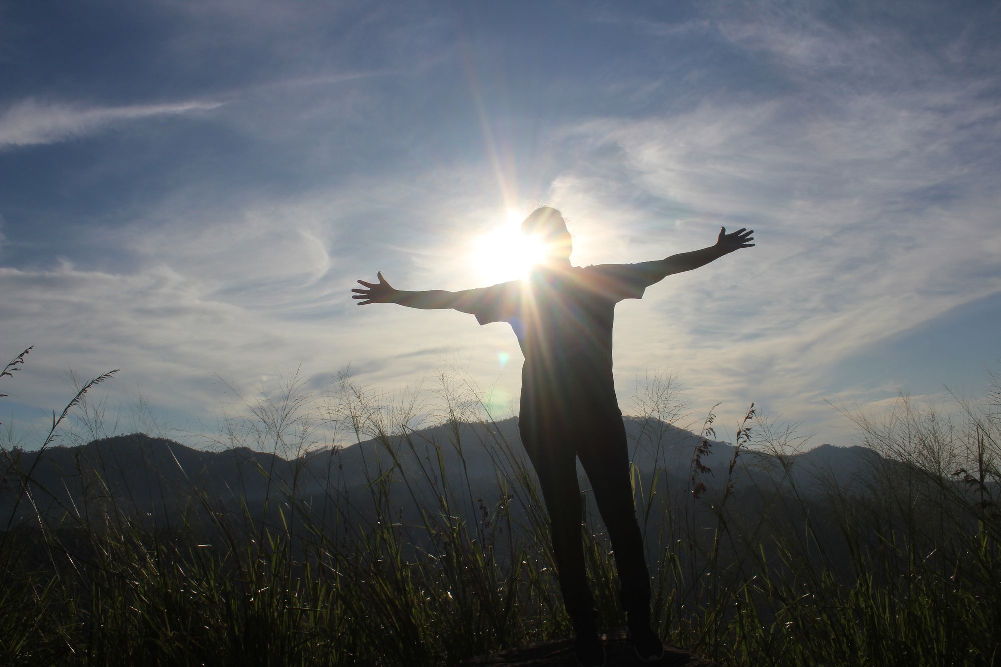 A girl enjoying the sunrise from Little Adam's Peak in Ella, Sri Lanka