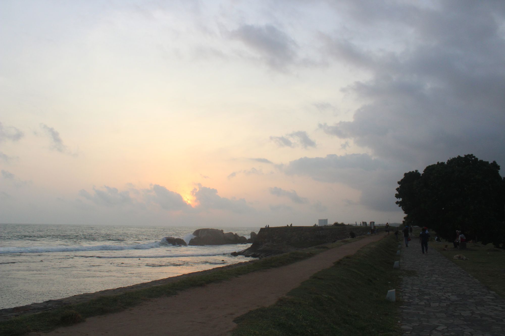 Ramparts of the Galle Dutch Fort with people walking around during the evening.