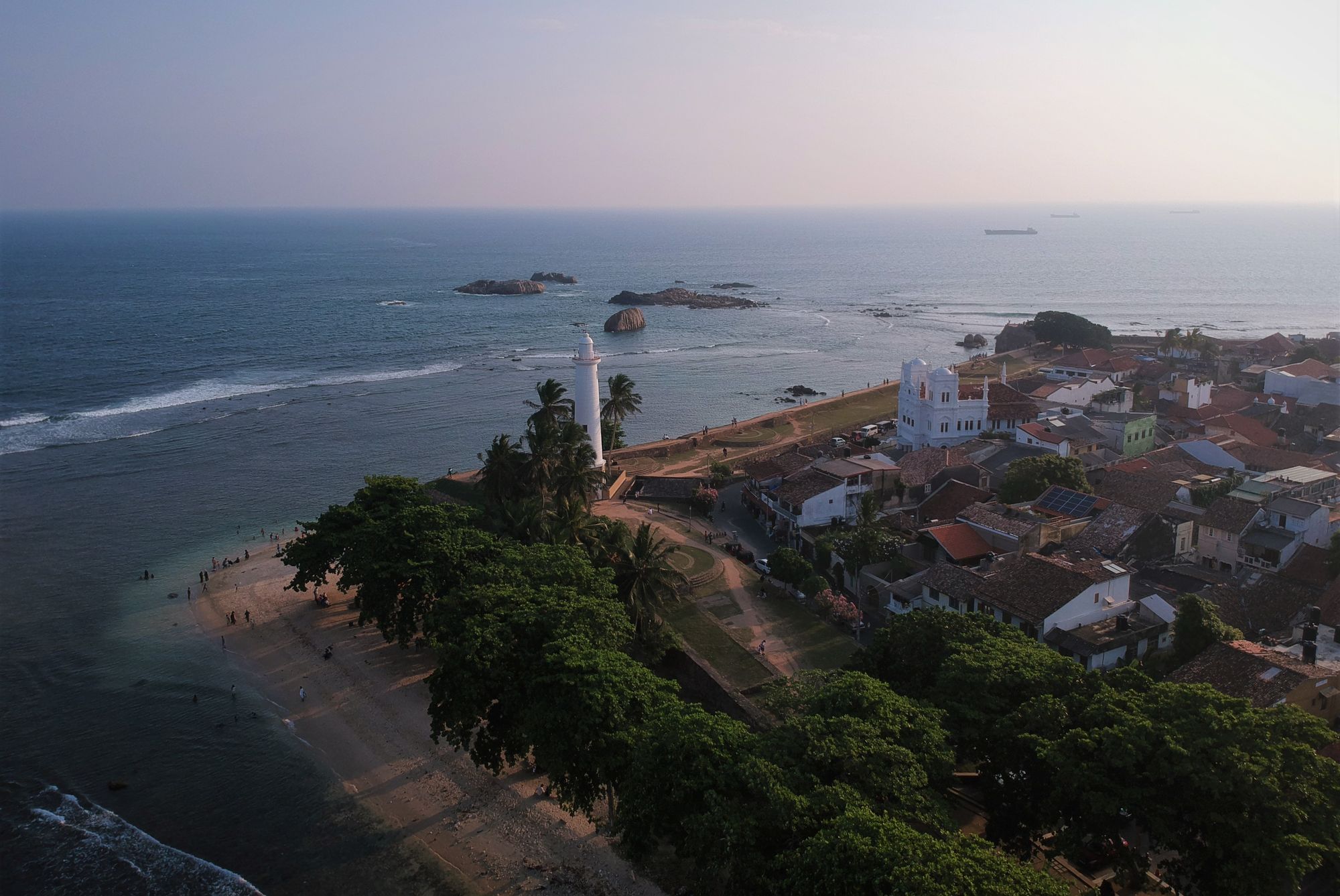 An aerial view of the part of the Galle Fort, Sri Lanka with the fort, the Galle Fort Lighthouse and the ocean in sight.