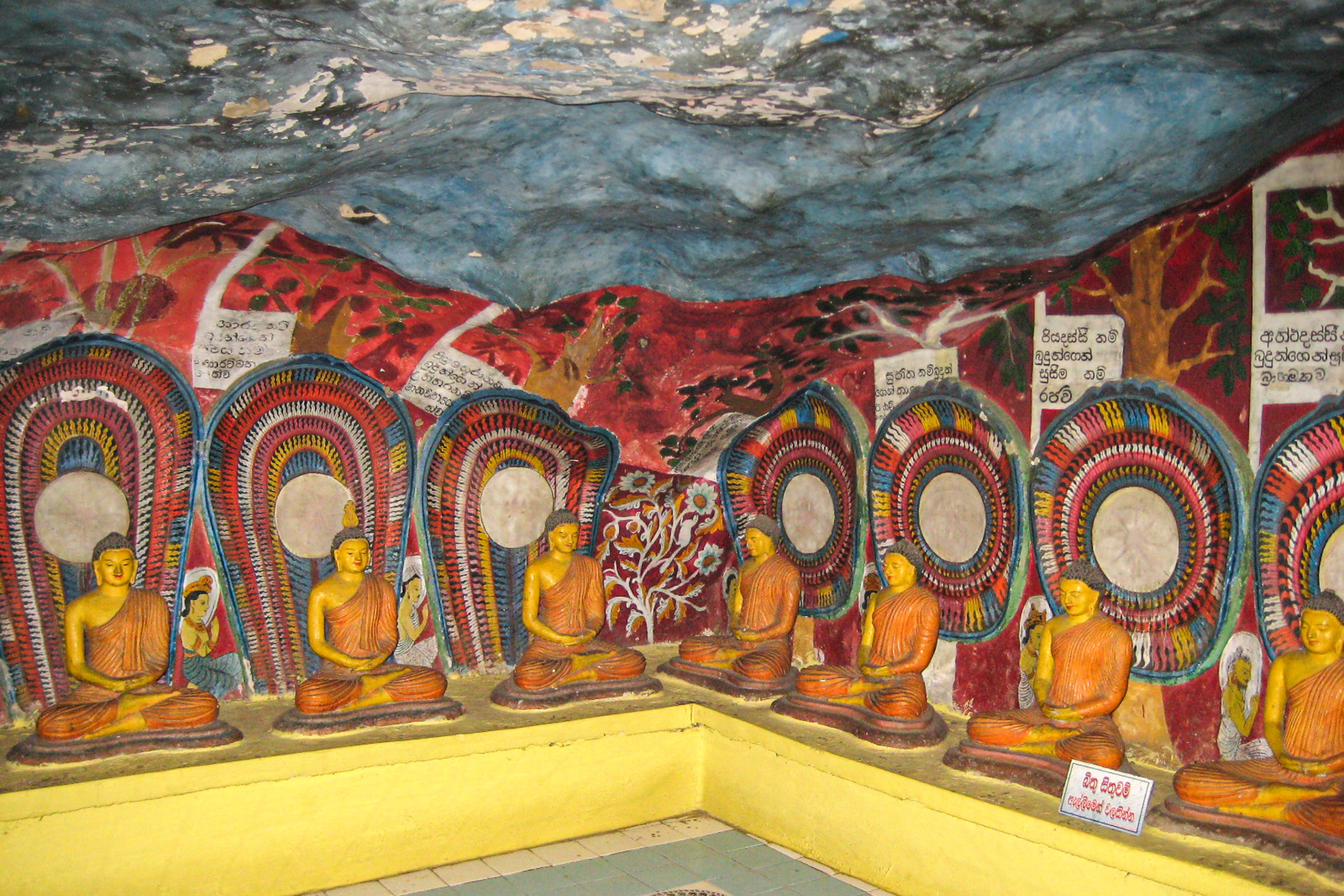 Buddha statues and paintings inside the Dhowa Rock Temple.