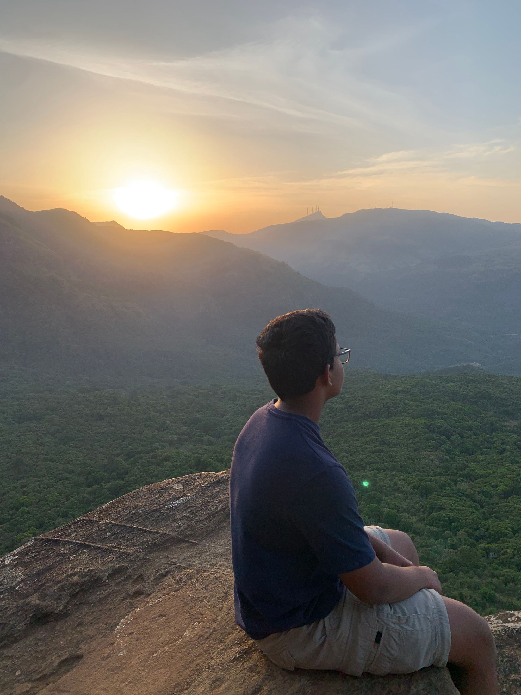 A boy admiring the sunset from Pitawala Pathana, Sri Lanka
