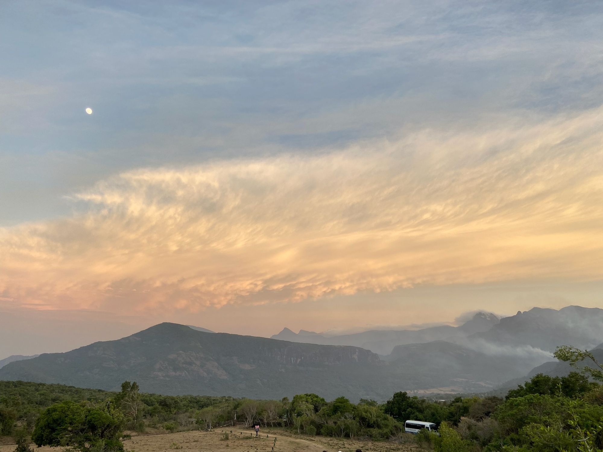 Pitawala Pathana in Riverston, Sri Lanka, with the mountains and cloudy, orange sky