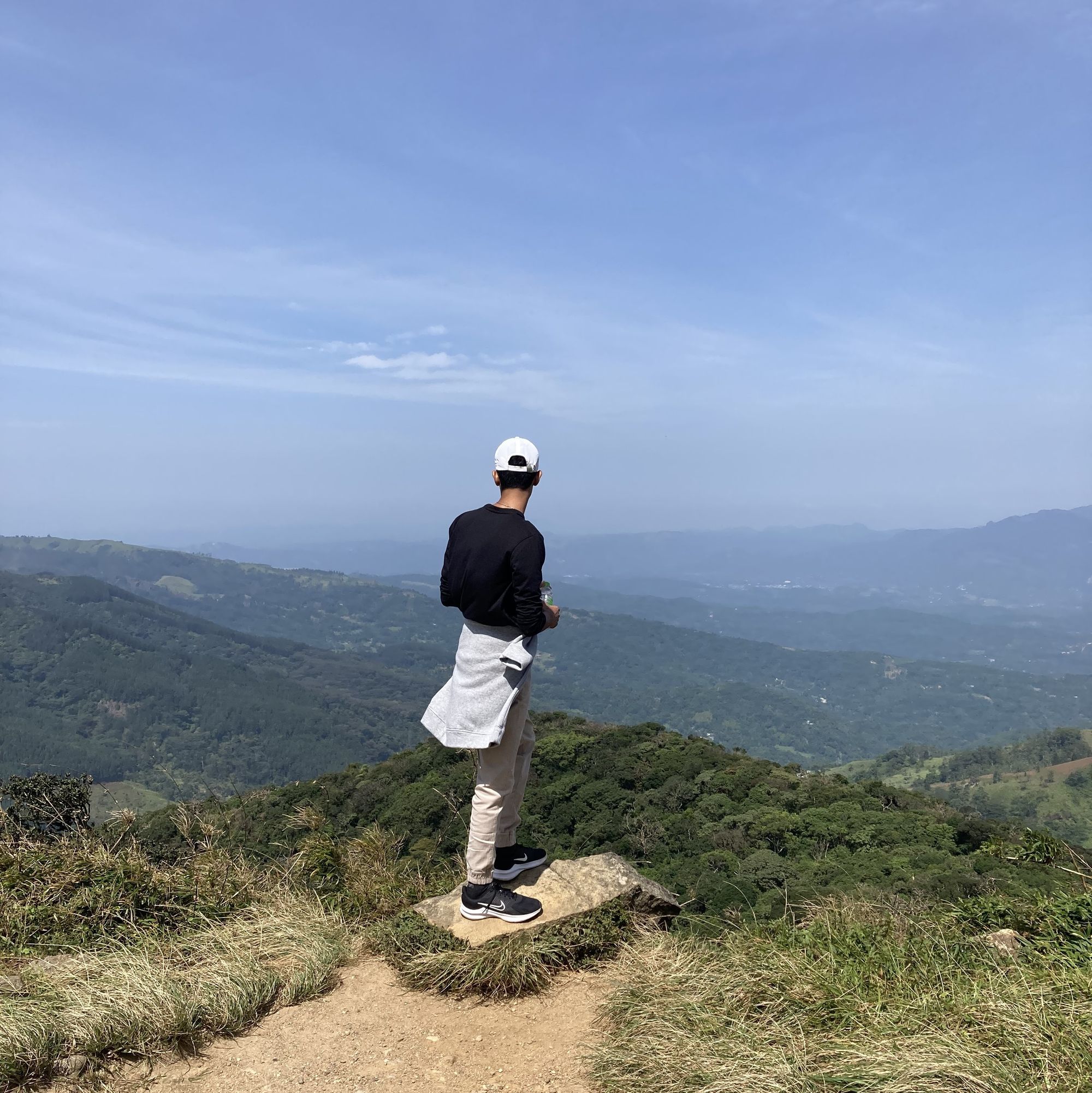 A boy admiring the view in Riverston Peak in Matale, Sri Lanka, during a hike