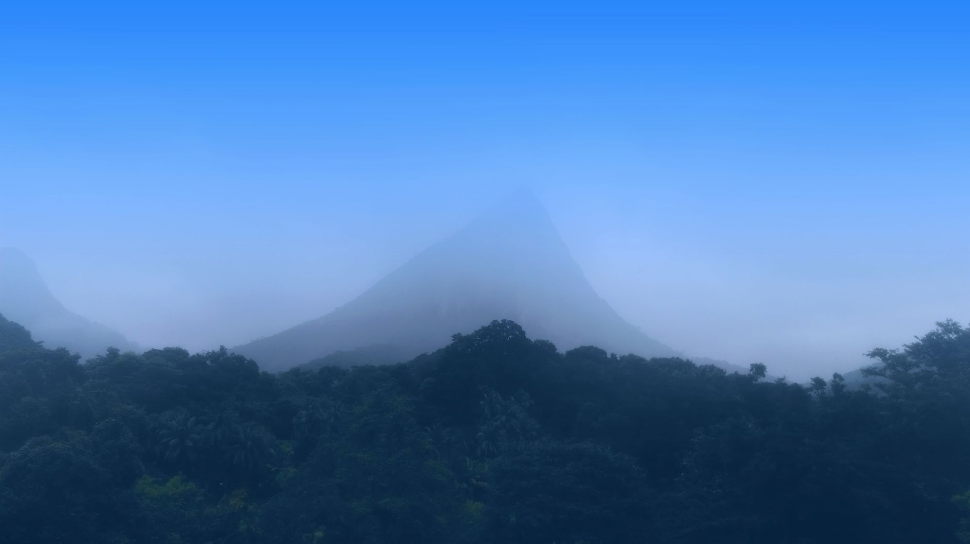 Lakegala Mountain in Meemure, Sri Lanka, covered in a blanket of mist