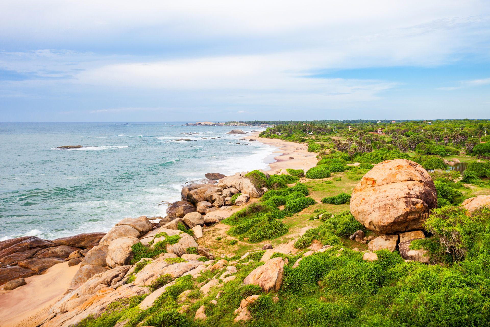 Rocky outcrops and greenery of Kirinda Beach in Sri Lanka